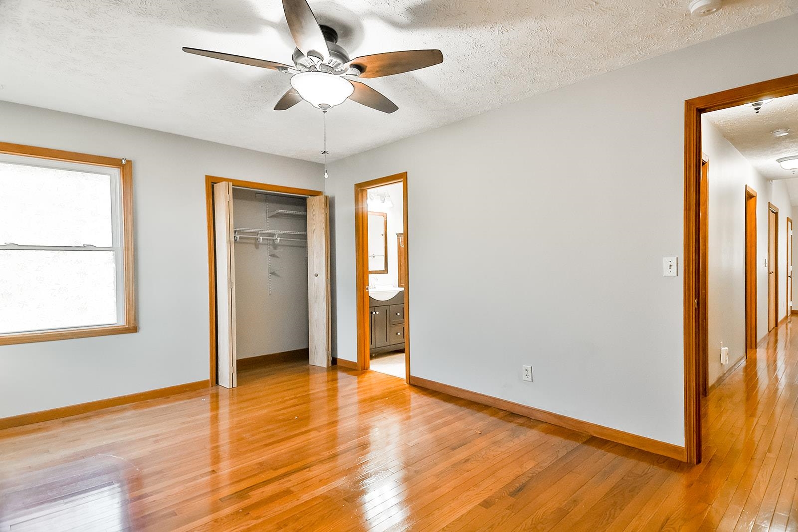 515 Pembroke Road Southwest Poplar Grove, IL 61065 - Photo 20 of 24 an empty room with wooden floor chandelier fan and windows