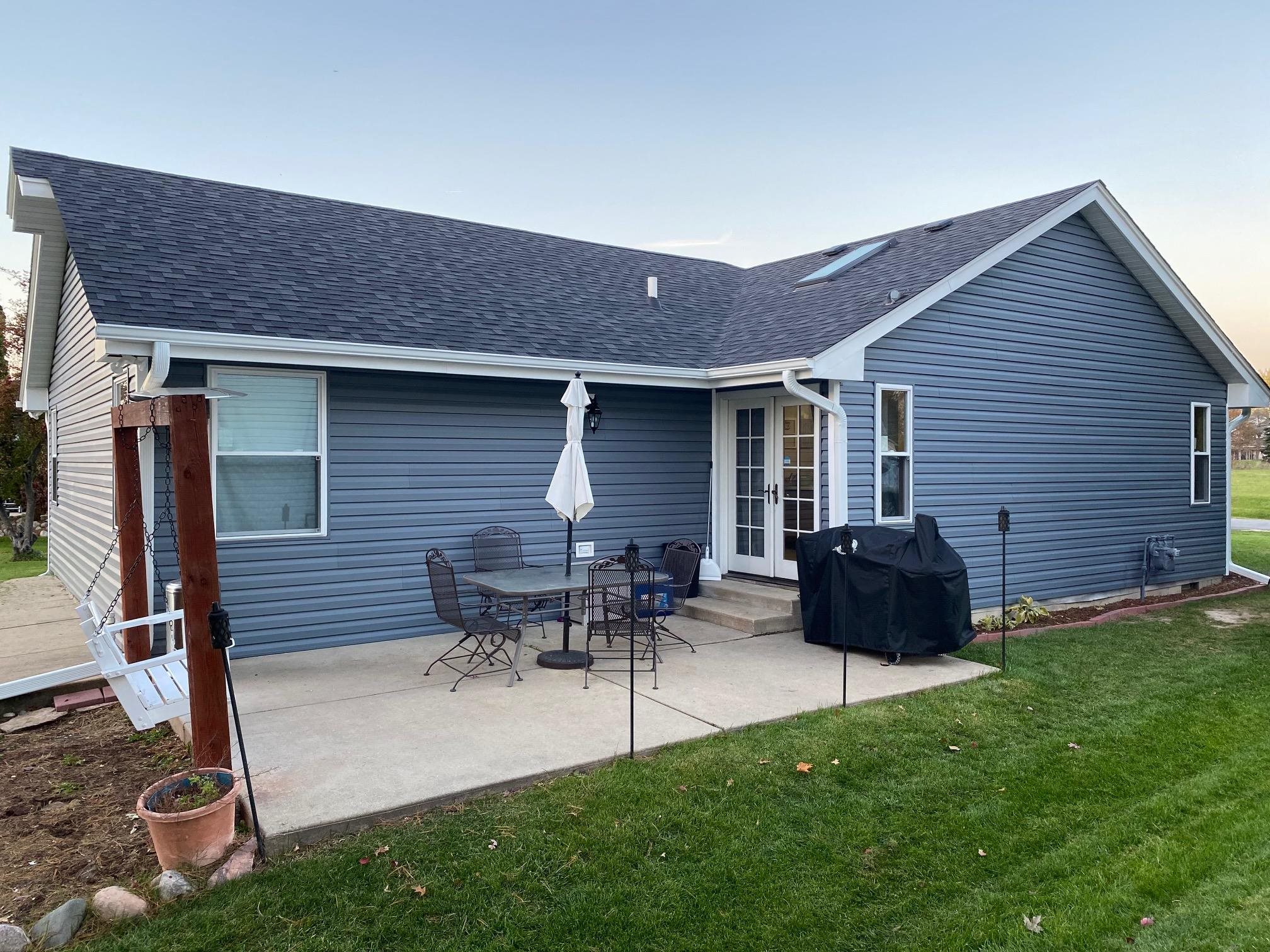 515 Pembroke Road Southwest Poplar Grove, IL 61065 - Photo 2 of 24 a backyard of a house with table and chairs