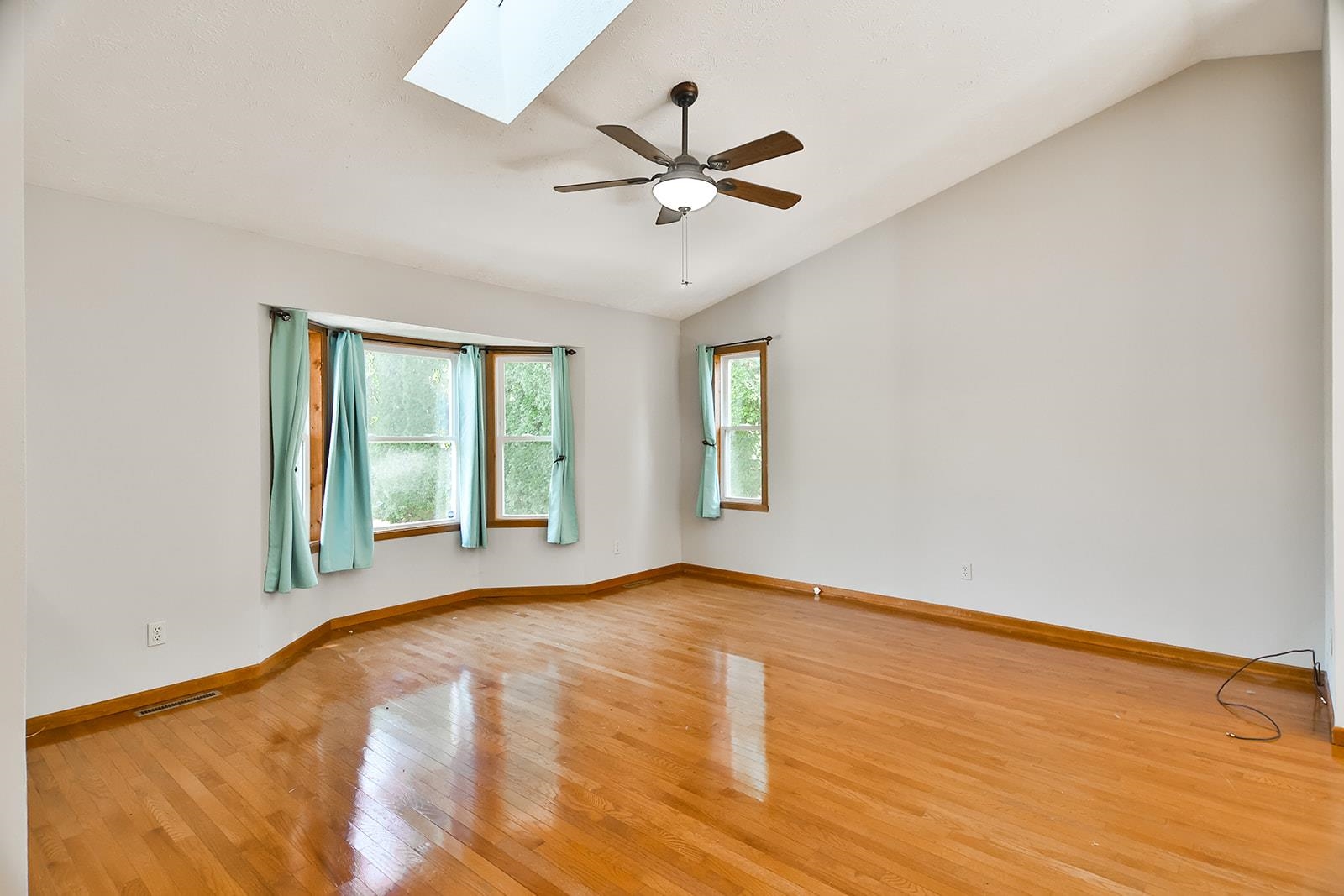 515 Pembroke Road Southwest Poplar Grove, IL 61065 - Photo 6 of 24 an empty room with wooden floor fan and windows