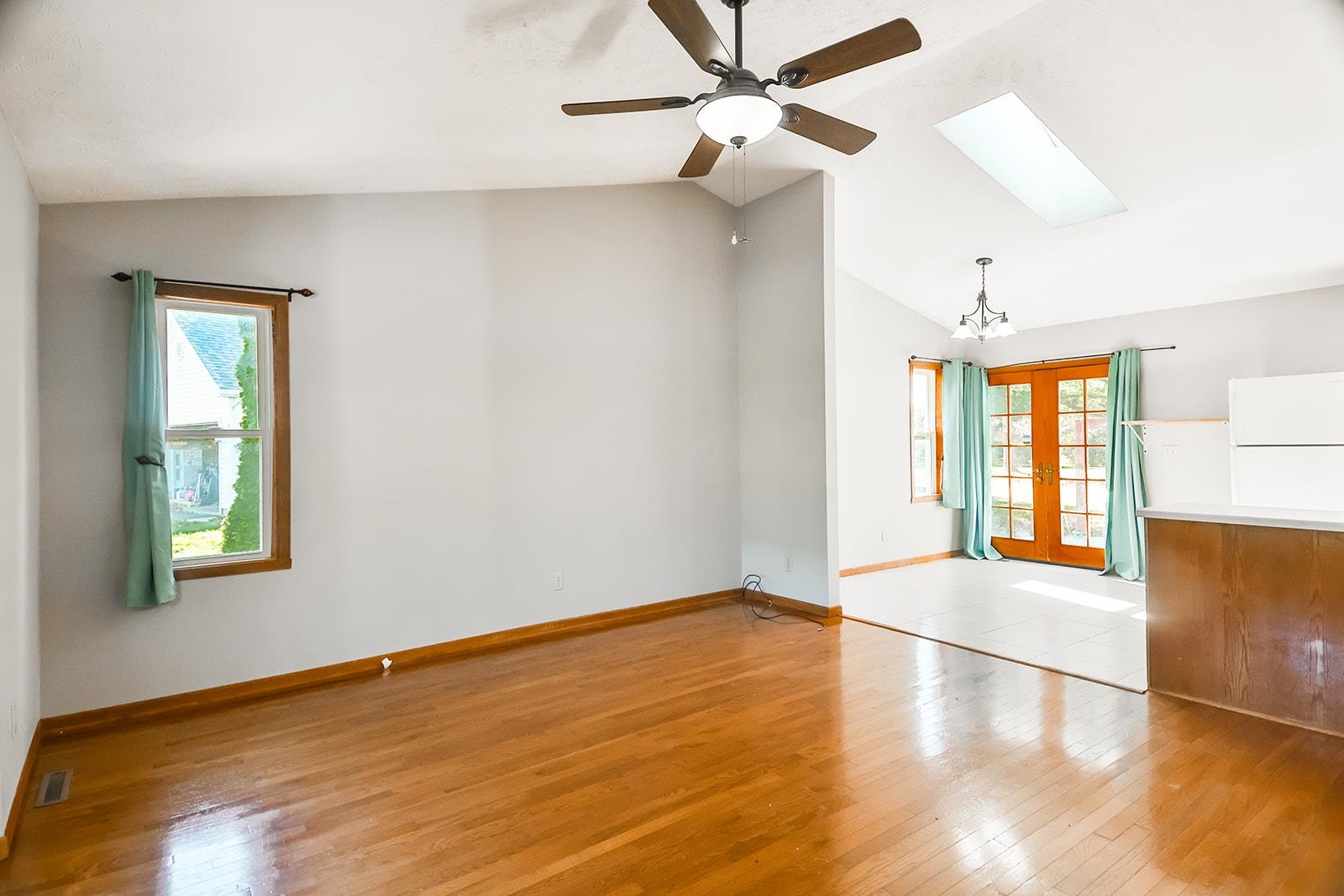 515 Pembroke Road Southwest Poplar Grove, IL 61065 - Photo 9 of 24 an empty room with wooden floor fan and windows