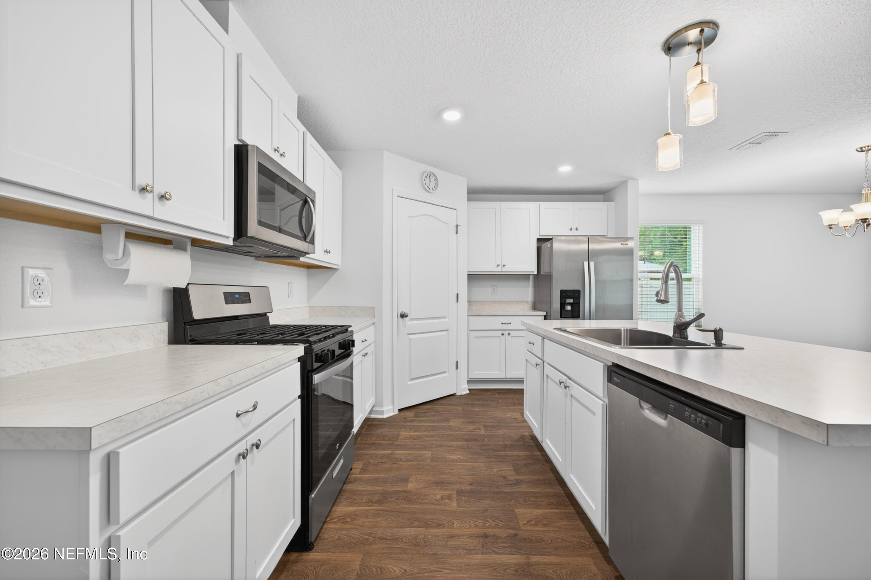 231 Encanto Way Street St. Augustine, FL 32084 - Photo 9 of 36 a kitchen with stainless steel appliances granite countertop a sink and dishwasher a stove top oven with white countertops