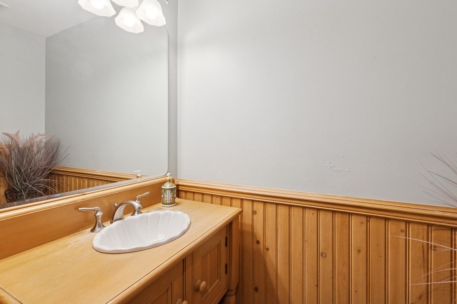 8100 South County Line Road Burr Ridge, IL 60527 - Photo 13 of 33 a bathroom with a sink and a mirror