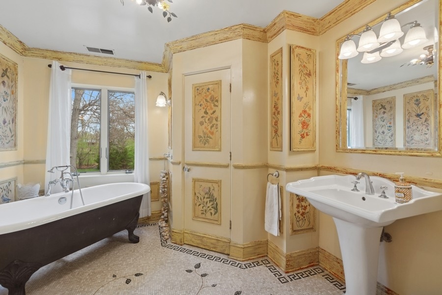 8100 South County Line Road Burr Ridge, IL 60527 - Photo 15 of 33 a bathroom with a tub sink shower and mirror
