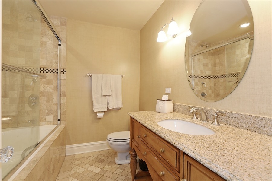 8100 South County Line Road Burr Ridge, IL 60527 - Photo 21 of 33 a bathroom with a granite countertop sink toilet and shower
