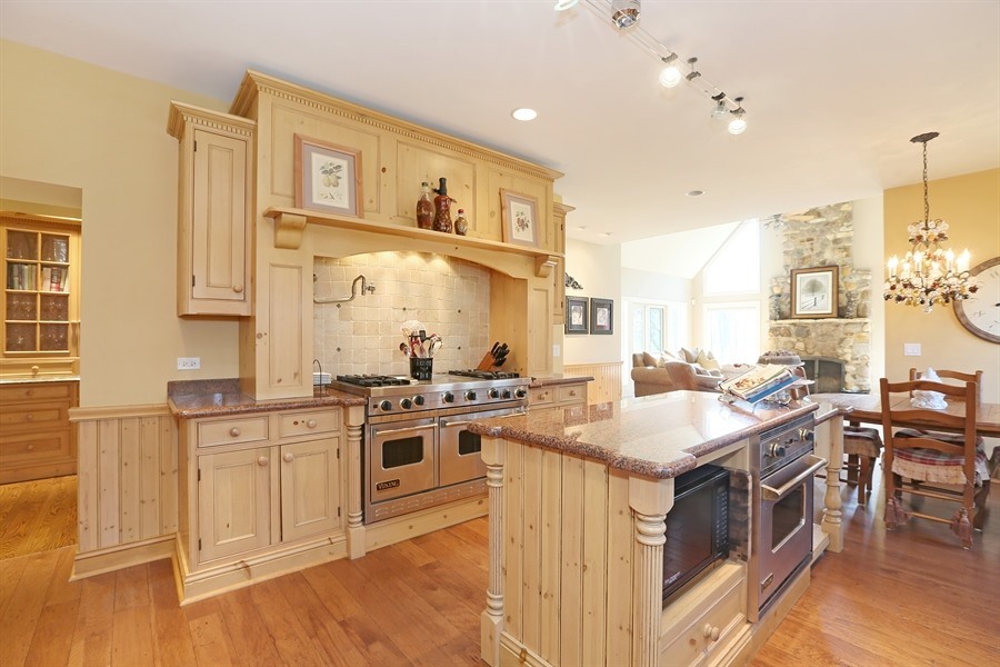 8100 South County Line Road Burr Ridge, IL 60527 - Photo 7 of 33 a kitchen with stainless steel appliances granite countertop a stove and chairs