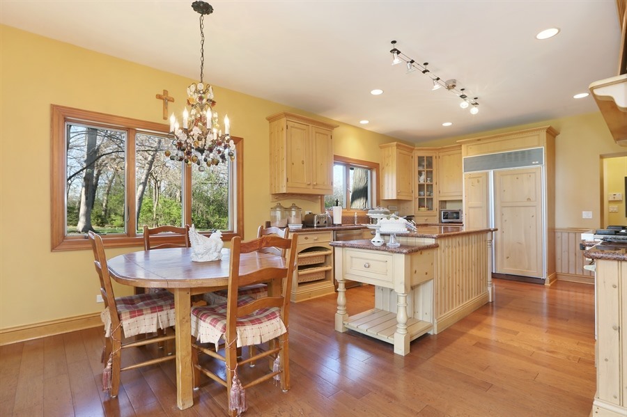 8100 South County Line Road Burr Ridge, IL 60527 - Photo 8 of 33 a large kitchen with a table and chairs