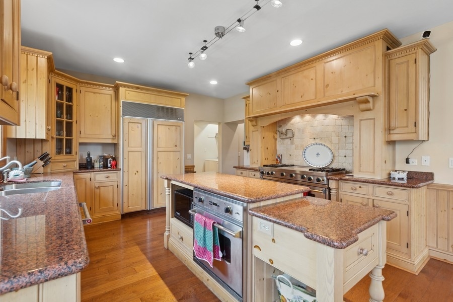 8100 South County Line Road Burr Ridge, IL 60527 - Photo 9 of 33 a large kitchen with stainless steel appliances granite countertop a sink and cabinets