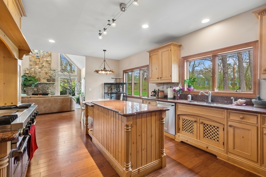 8100 South County Line Road Burr Ridge, IL 60527 - Photo 10 of 33 a kitchen with counter top space windows and a chandelier