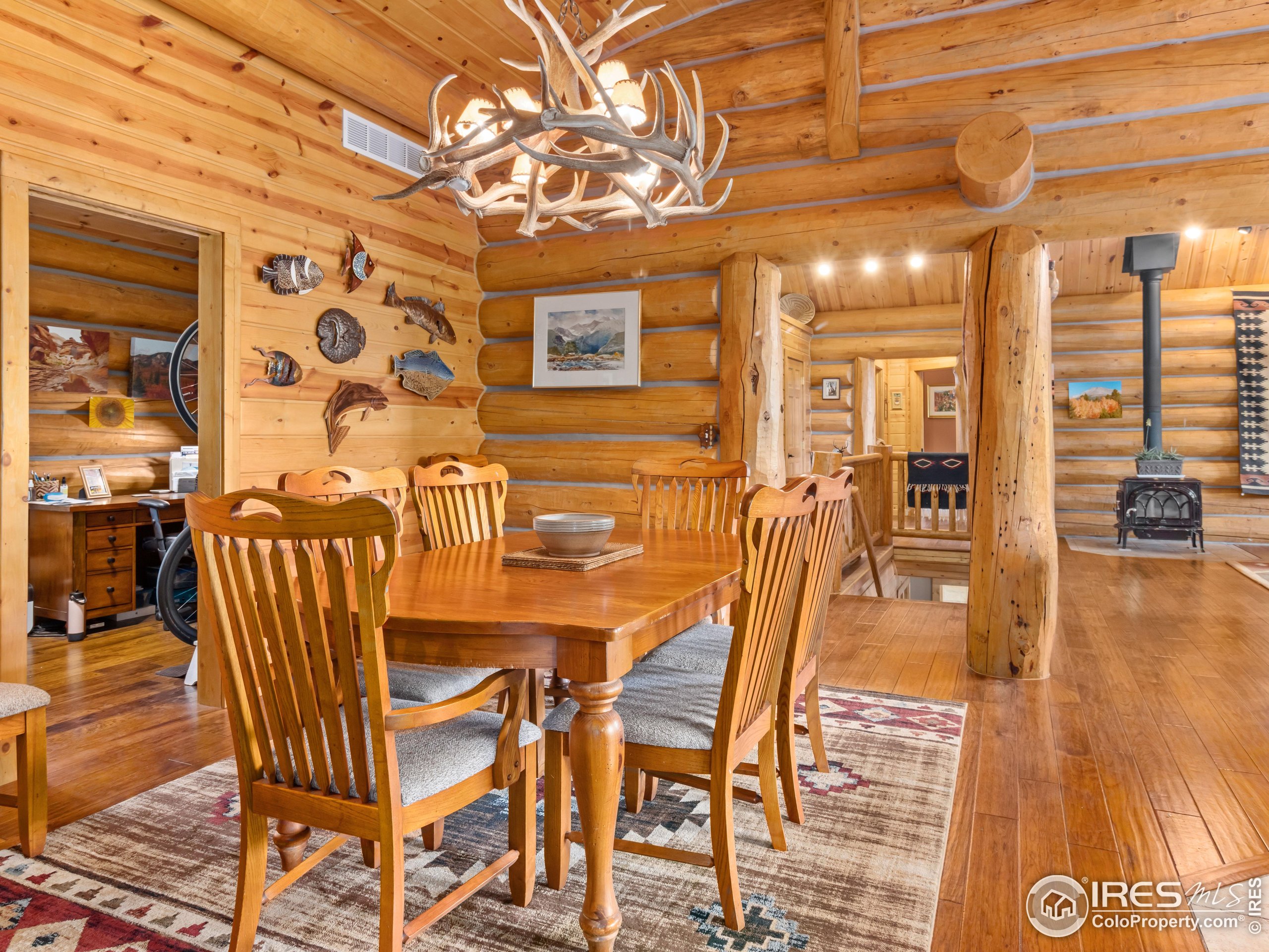 470 Big John Road Lyons, CO 80540 - Photo 13 of 38 a dining room with furniture and wooden floor