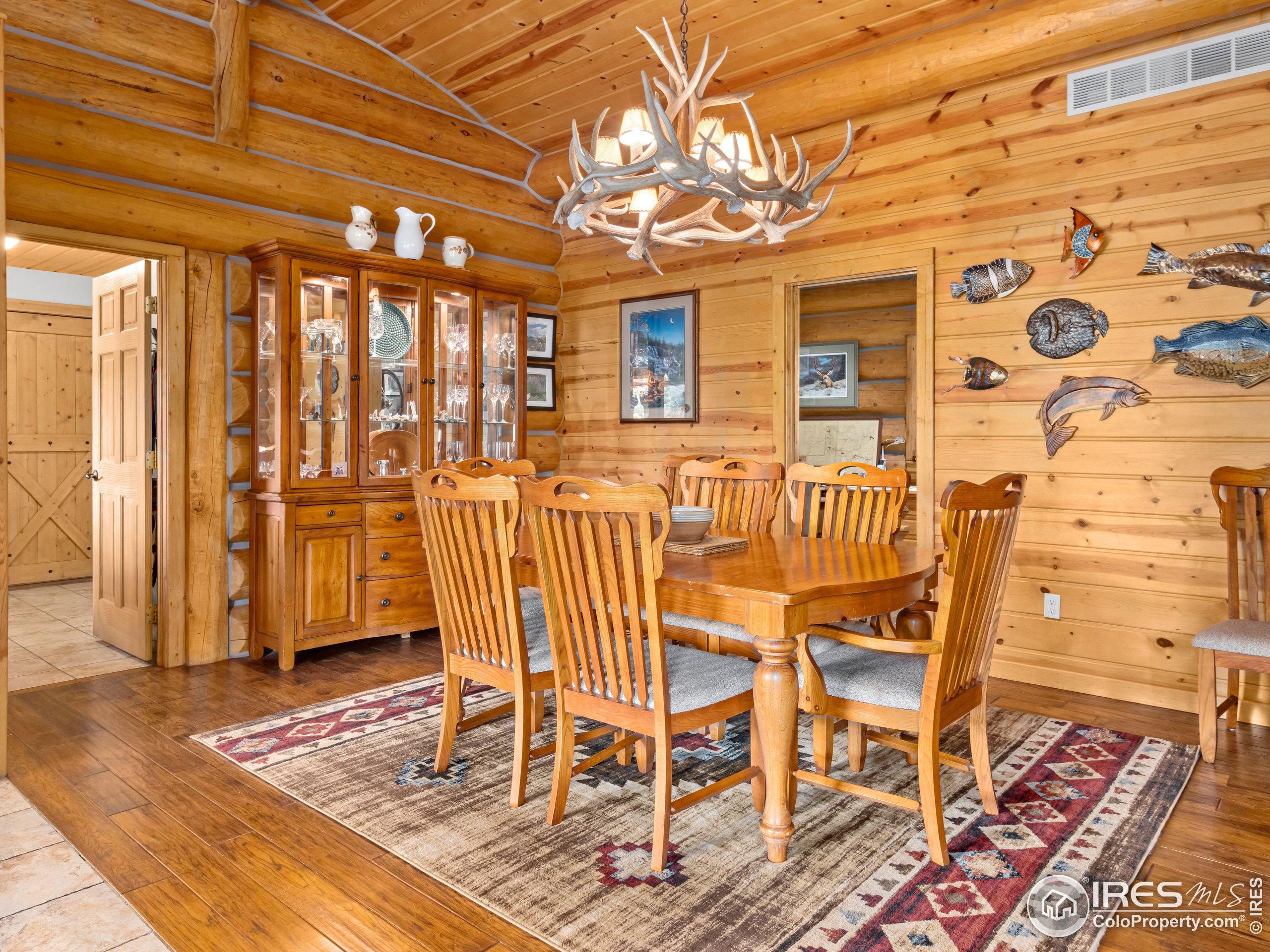 470 Big John Road Lyons, CO 80540 - Photo 14 of 38 a dining room with wooden floor and door