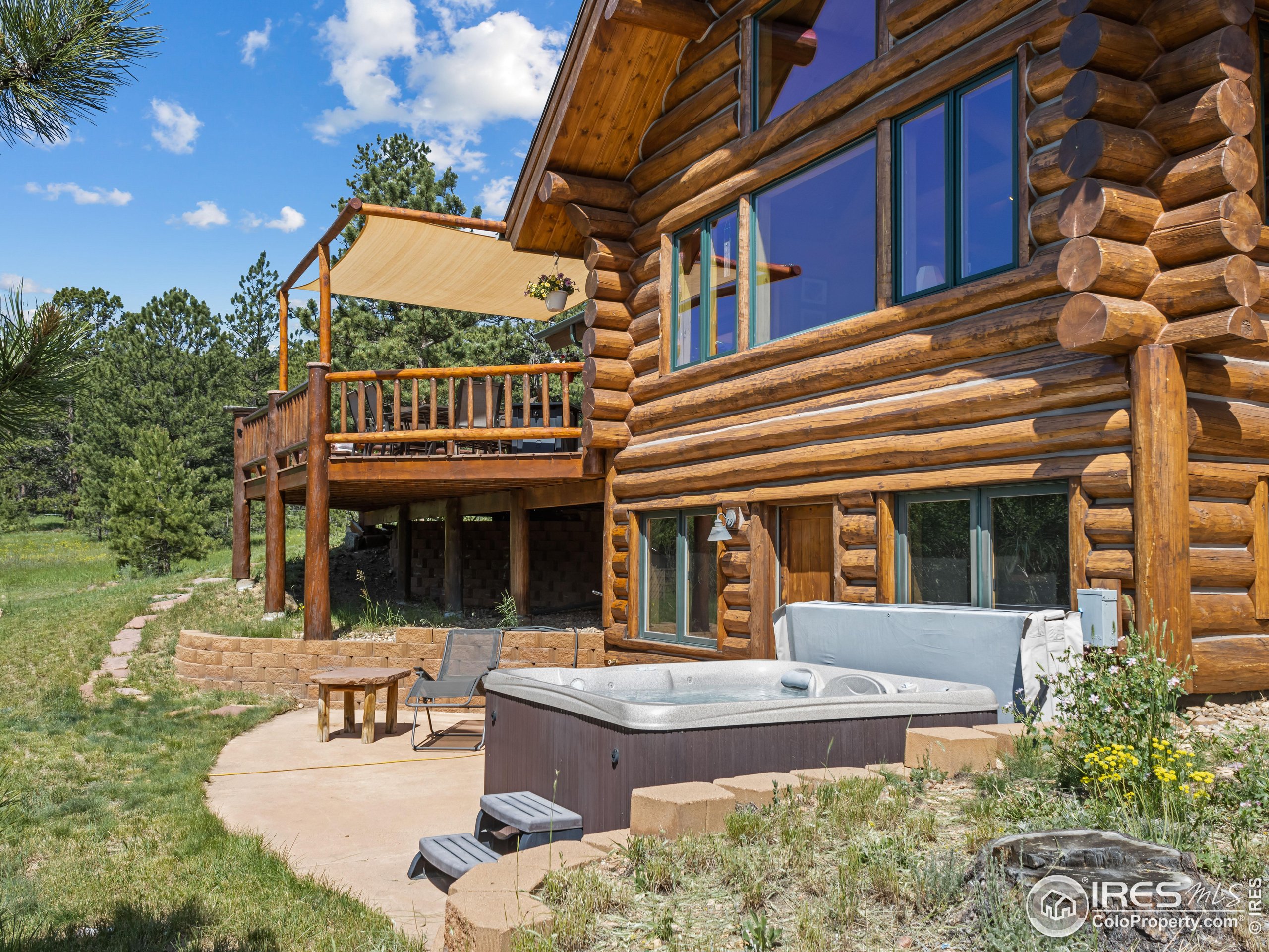 470 Big John Road Lyons, CO 80540 - Photo 2 of 38 front view of a building with a garden