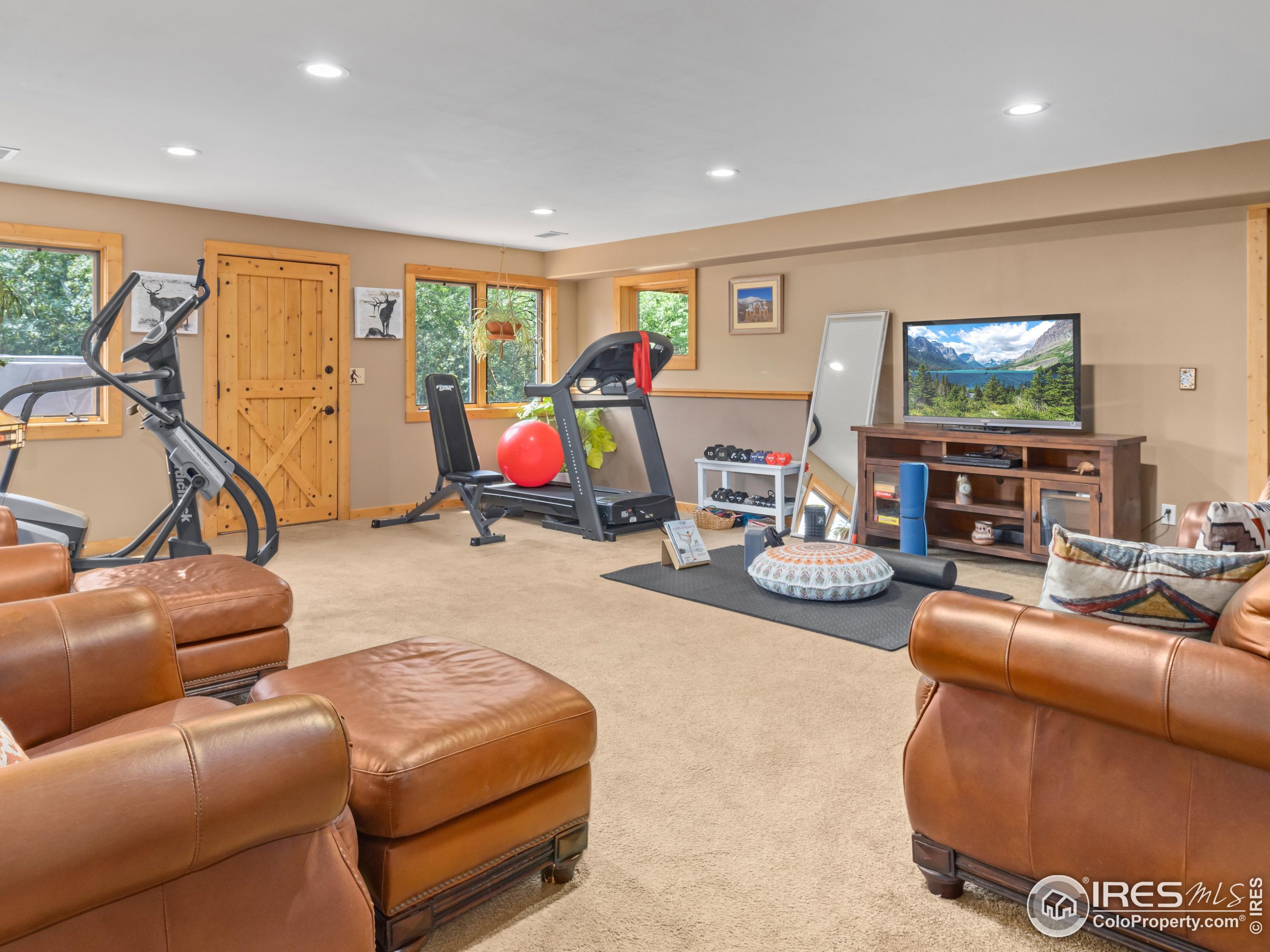 470 Big John Road Lyons, CO 80540 - Photo 25 of 38 a living room with furniture a flat screen tv and a large window