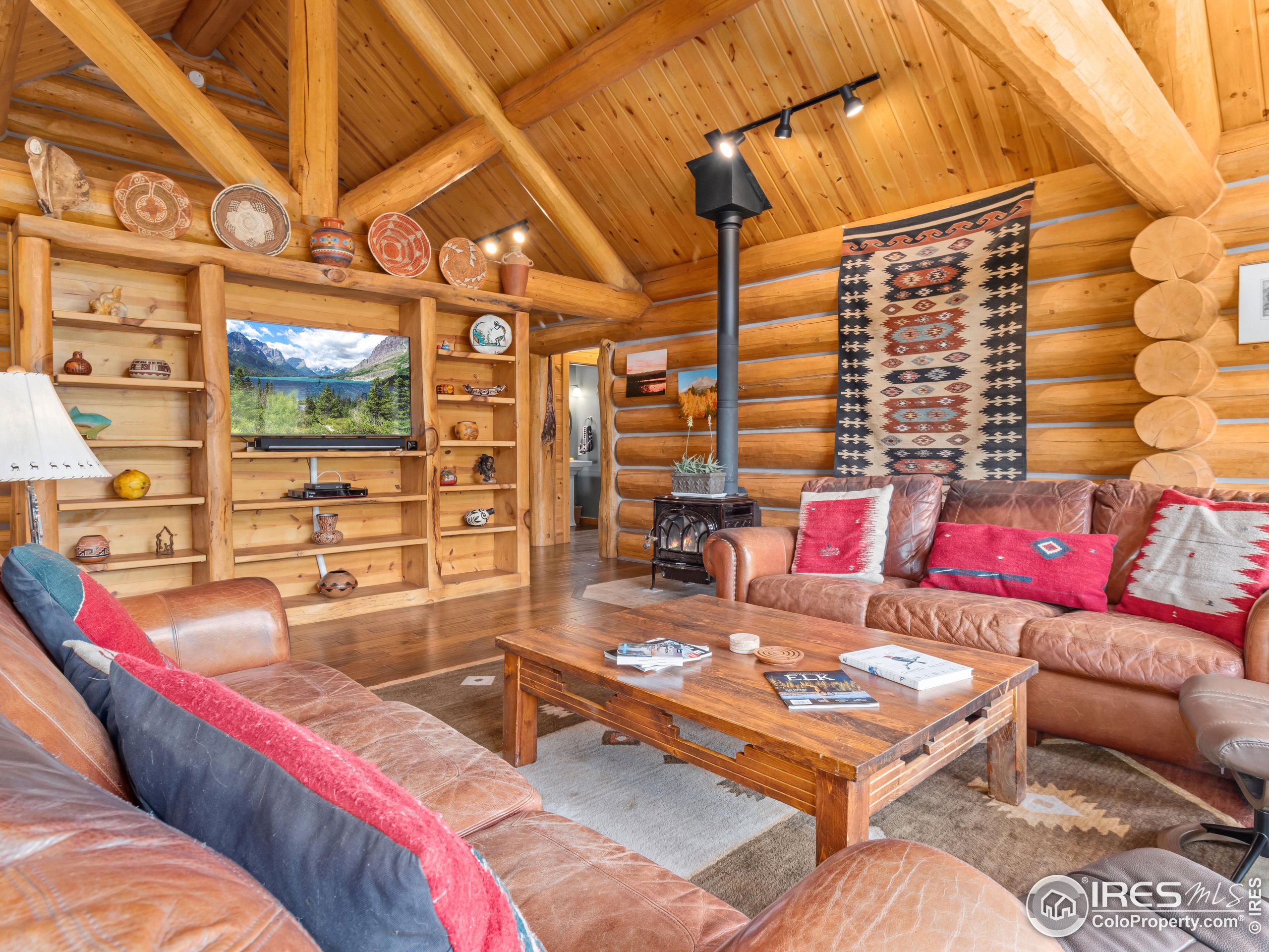470 Big John Road Lyons, CO 80540 - Photo 10 of 38 a living room with furniture and a flat screen tv