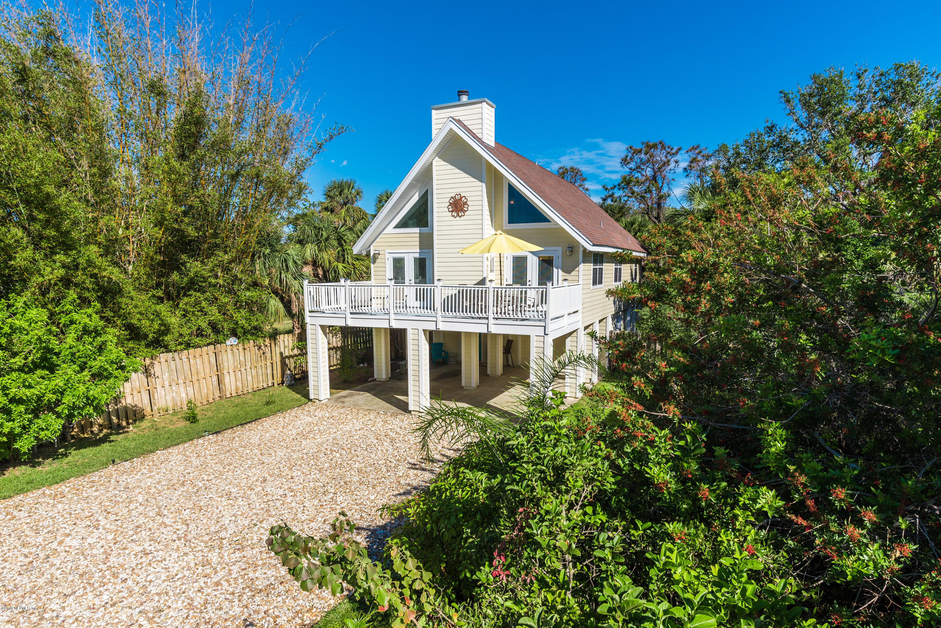 64 Manresa Road St. Augustine, FL 32084 - Photo 1 of 31 a front view of a house with a garden