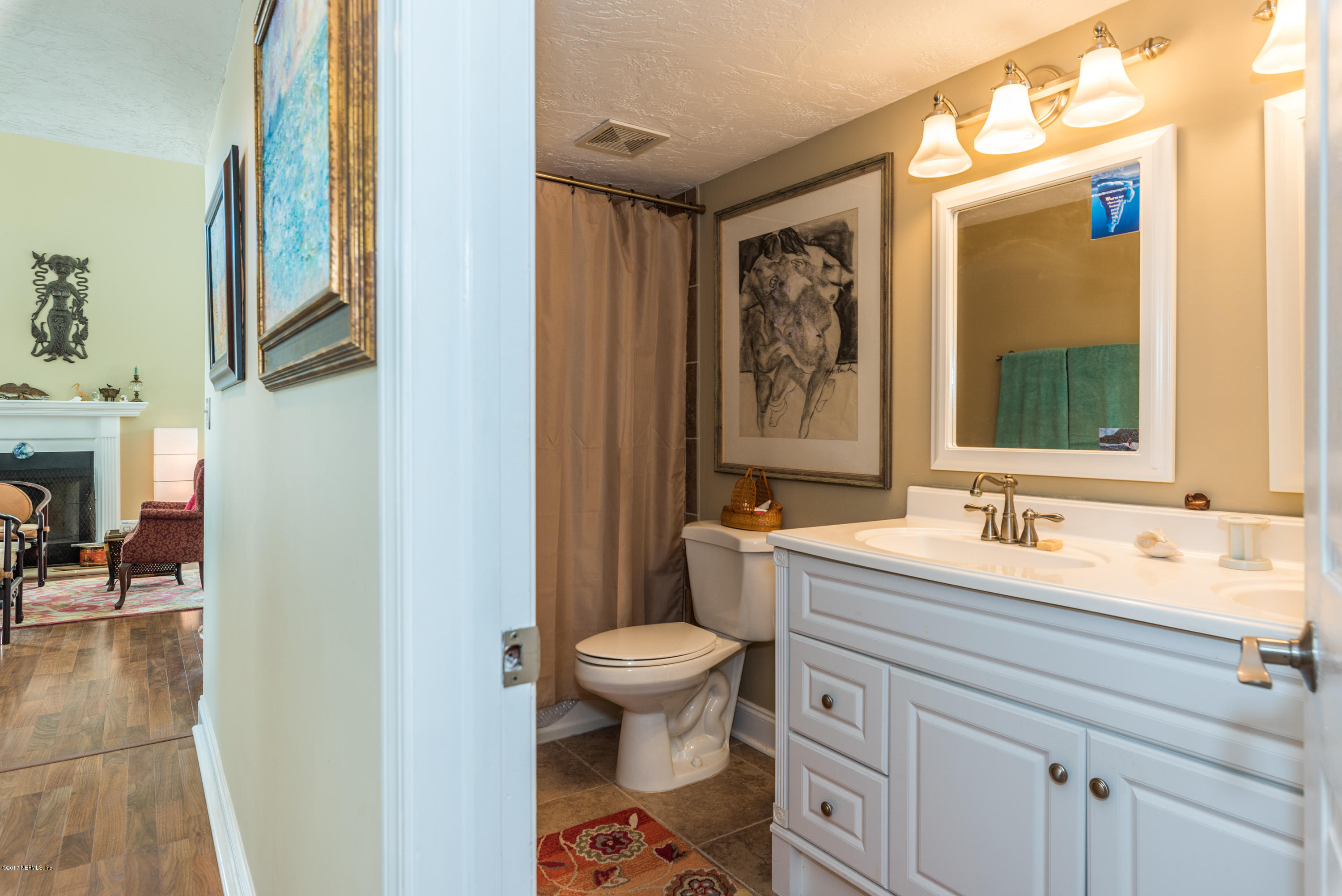 64 Manresa Road St. Augustine, FL 32084 - Photo 13 of 31 a bathroom with a granite countertop sink toilet and mirror