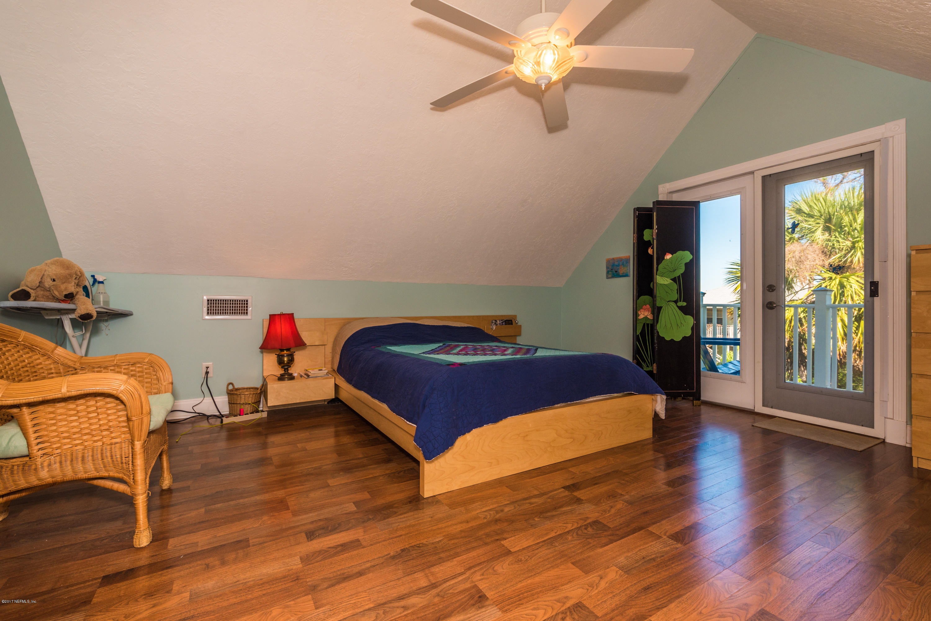 64 Manresa Road St. Augustine, FL 32084 - Photo 19 of 31 a bedroom with a bed and wooden floor