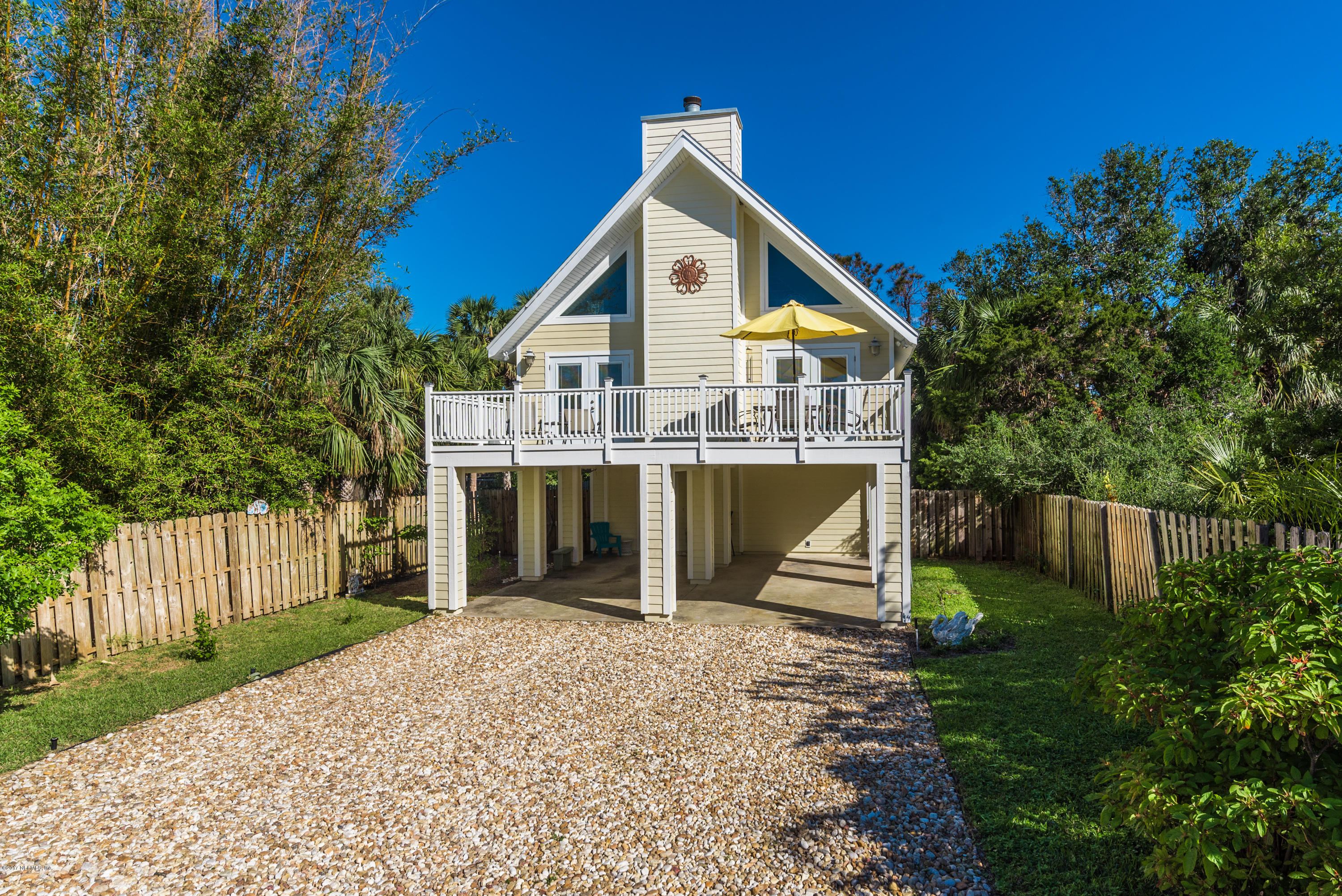 64 Manresa Road St. Augustine, FL 32084 - Photo 2 of 31 a front view of a house with a yard and trees