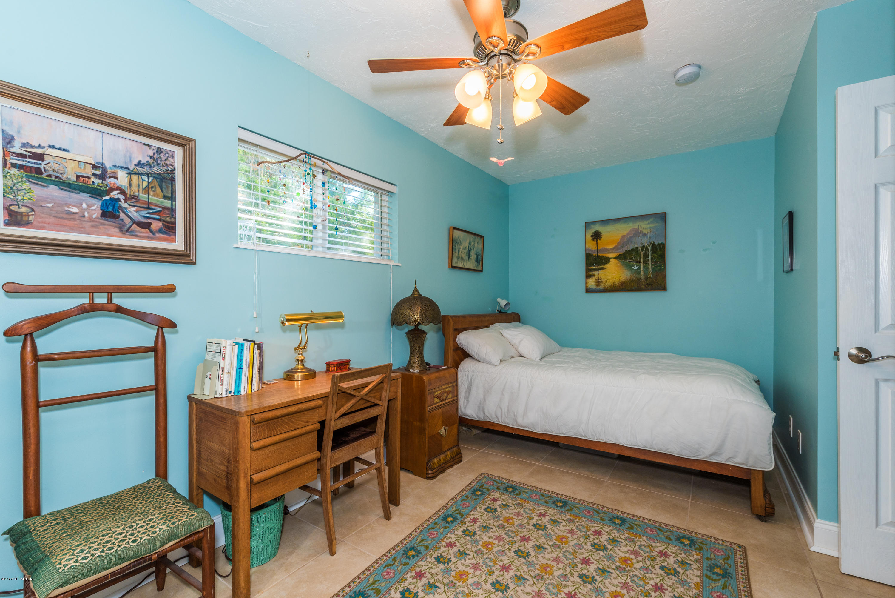 64 Manresa Road St. Augustine, FL 32084 - Photo 5 of 31 a bedroom with a bed and a chandelier