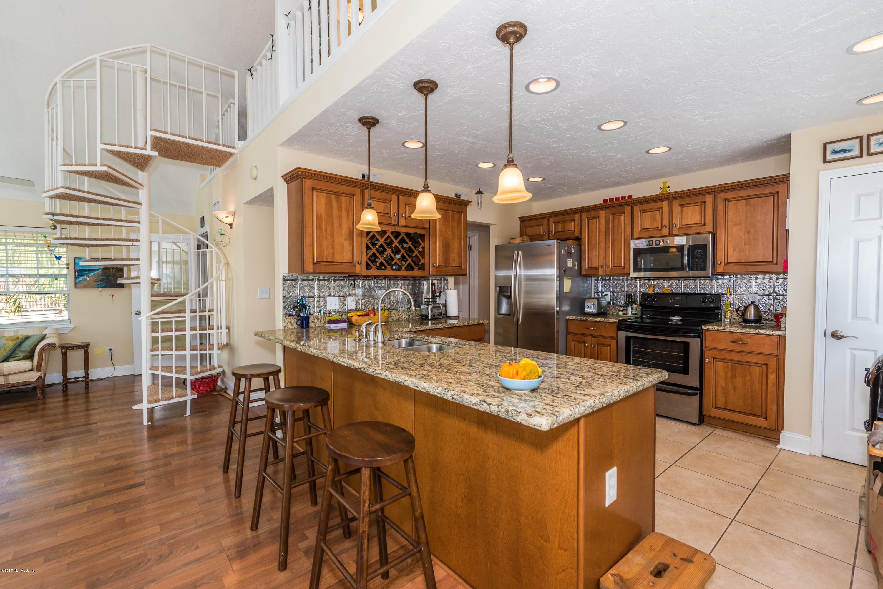 64 Manresa Road St. Augustine, FL 32084 - Photo 10 of 31 a kitchen with stainless steel appliances granite countertop a stove a sink a refrigerator and chairs