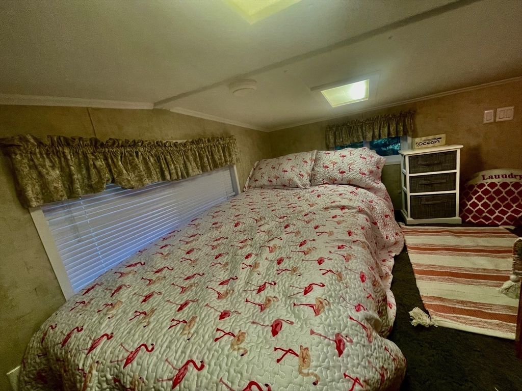 185 Cotuit Road, Unit C5 ASPEN Sandwich, MA 02563 - Photo 14 of 17 a bed sitting in a bedroom next to a window
