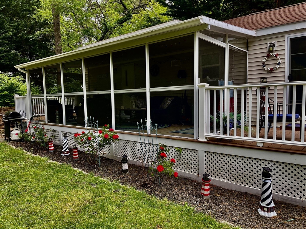 185 Cotuit Road, Unit C5 ASPEN Sandwich, MA 02563 - Photo 2 of 17 a view of a house with a large window and flower garden