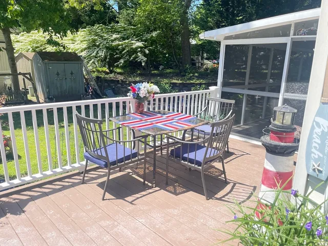 a view of a chairs and table in the roof deck