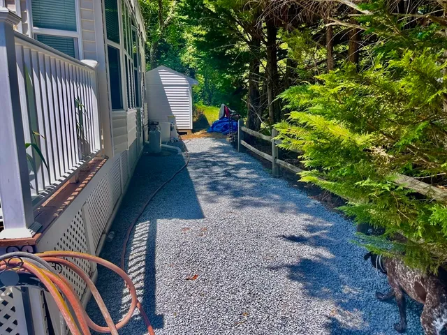 a view of a wooden chairs and backyard in the garden