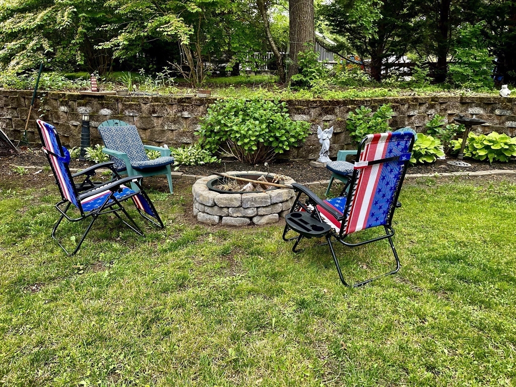 185 Cotuit Road, Unit C5 ASPEN Sandwich, MA 02563 - Photo 8 of 17 a view of a wooden chairs and backyard in the garden