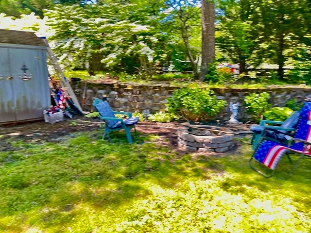 a backyard of a house with table and chairs