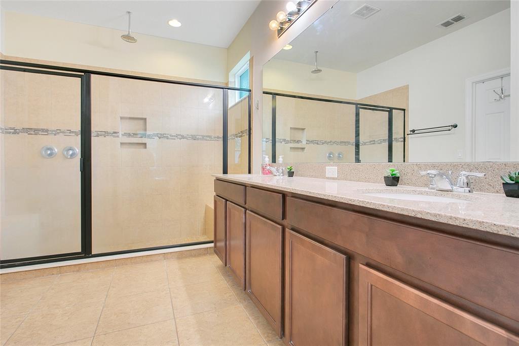 4918 Wildwood Pointe Road Winter Garden, FL 34787 - Photo 12 of 33 a bathroom with a double vanity sink and a mirror