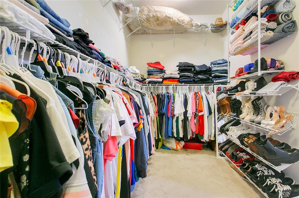 4918 Wildwood Pointe Road Winter Garden, FL 34787 - Photo 13 of 33 a view of walk in closet with clothes