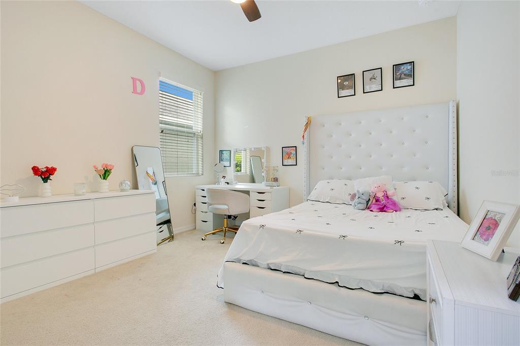 4918 Wildwood Pointe Road Winter Garden, FL 34787 - Photo 16 of 33 a bedroom with a bed and a table