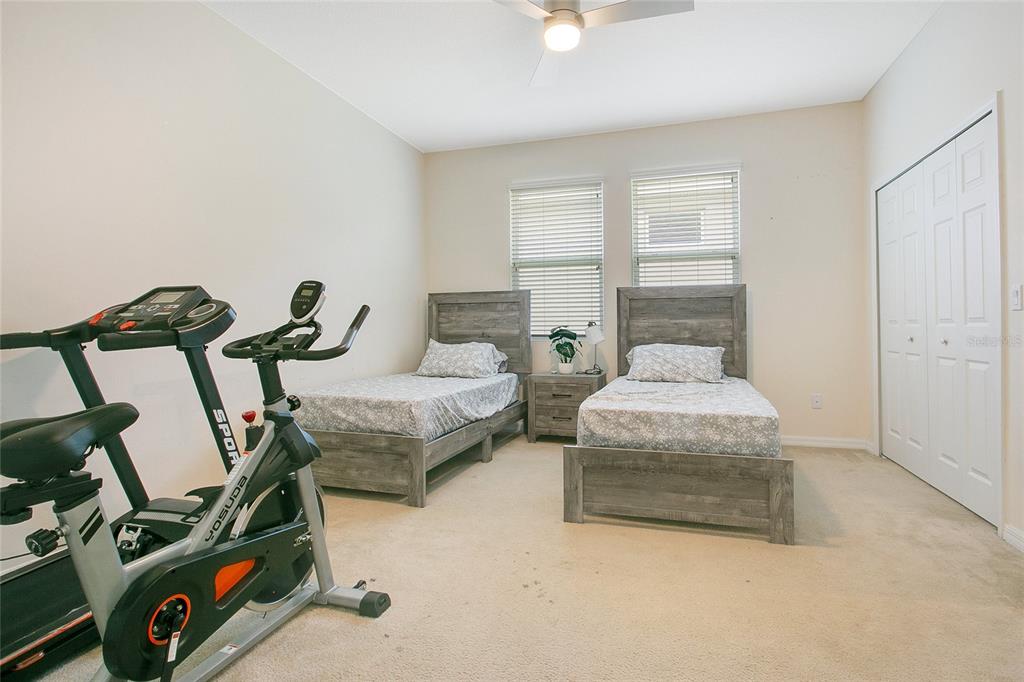 4918 Wildwood Pointe Road Winter Garden, FL 34787 - Photo 19 of 33 a bedroom with bed and window