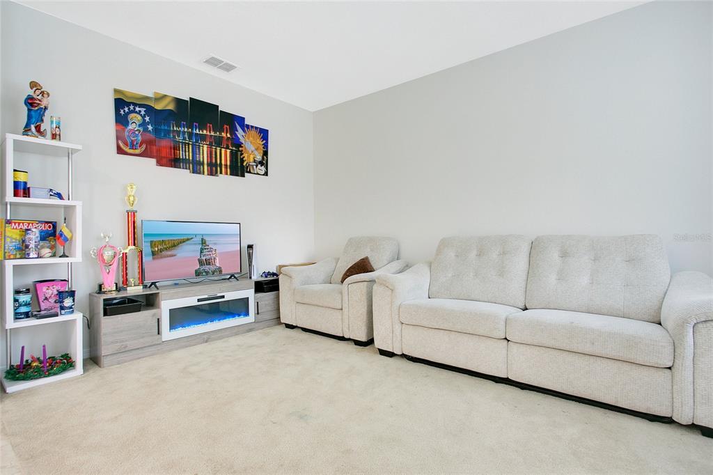 4918 Wildwood Pointe Road Winter Garden, FL 34787 - Photo 20 of 33 a living room with furniture and a couch