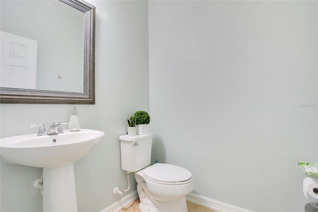 4918 Wildwood Pointe Road Winter Garden, FL 34787 - Photo 21 of 33 a bathroom with a sink toilet and a mirror