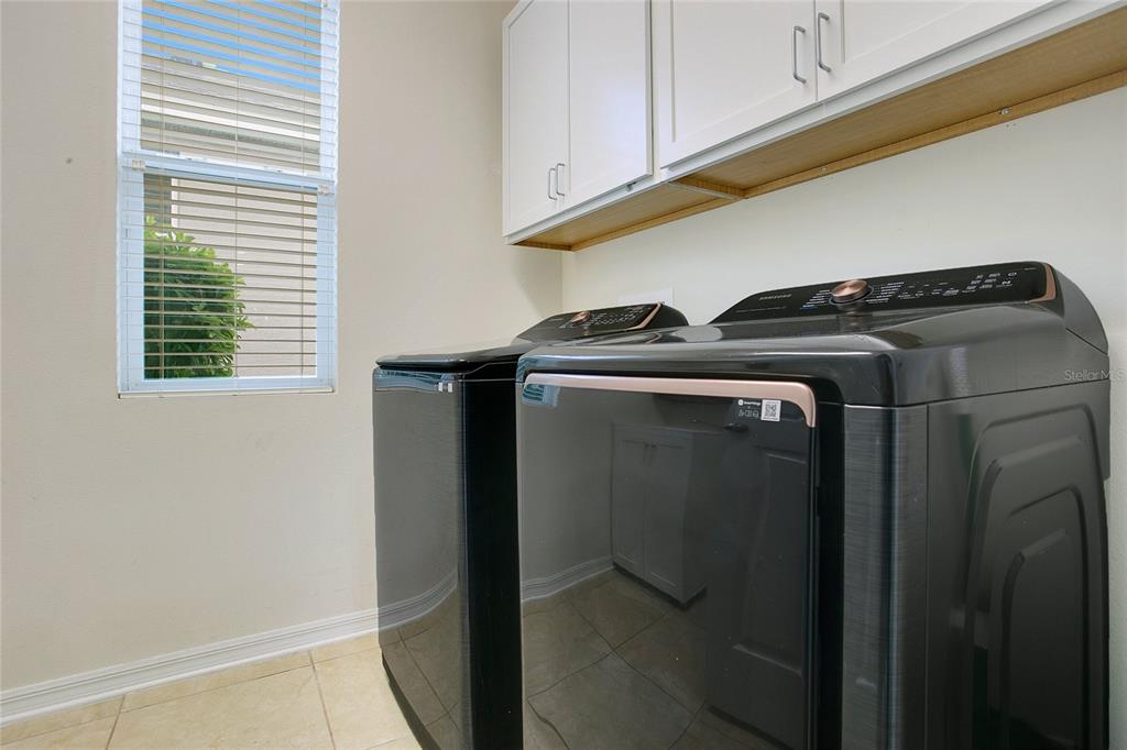 4918 Wildwood Pointe Road Winter Garden, FL 34787 - Photo 22 of 33 a close view of a refrigerator in kitchen and cabinets