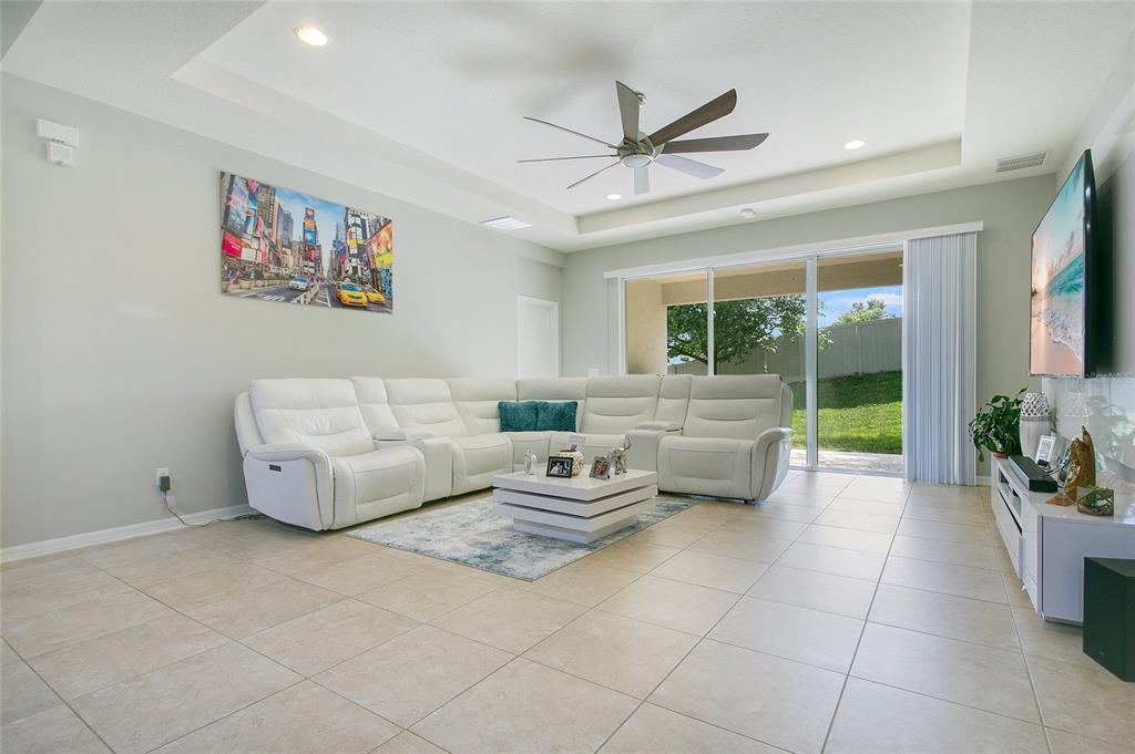 4918 Wildwood Pointe Road Winter Garden, FL 34787 - Photo 3 of 33 a living room with furniture and a large window