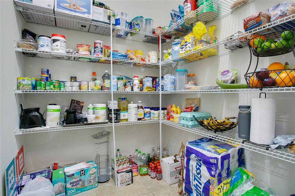 4918 Wildwood Pointe Road Winter Garden, FL 34787 - Photo 9 of 33 a store room with lots of different kinds of food and flowers