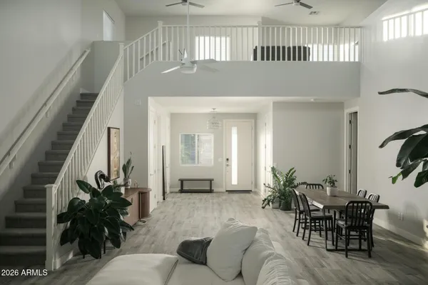 a living room with furniture and a potted plant