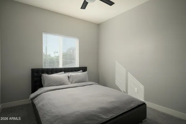 a bedroom with a bed and window