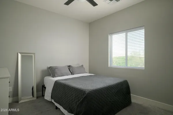 a bedroom with a bed and window