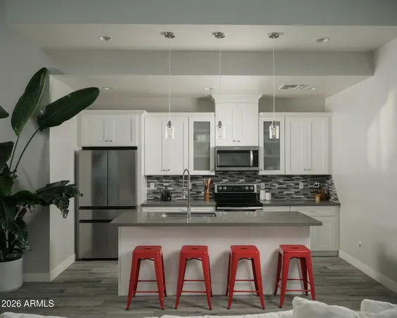 a kitchen with stainless steel appliances granite countertop a refrigerator and microwave