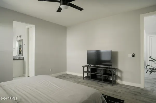 a bedroom with a bed and a flat screen tv