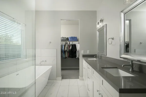 a bathroom with a granite countertop sink tub and a mirror