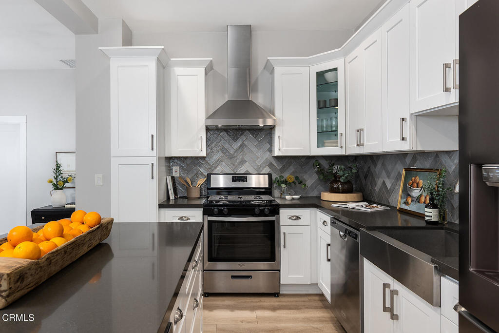 2040 North Madison Avenue Altadena, CA 91001 - Photo 12 of 35 a kitchen with stainless steel appliances granite countertop a stove a sink and a white cabinets