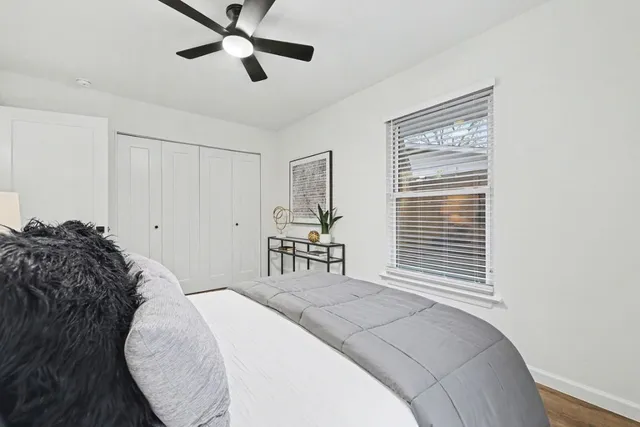 a bedroom with a bed and a lamp