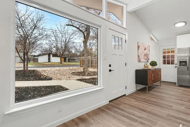 a view of a livingroom with wooden floor and furniture