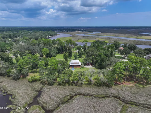 a view of a field with an ocean view