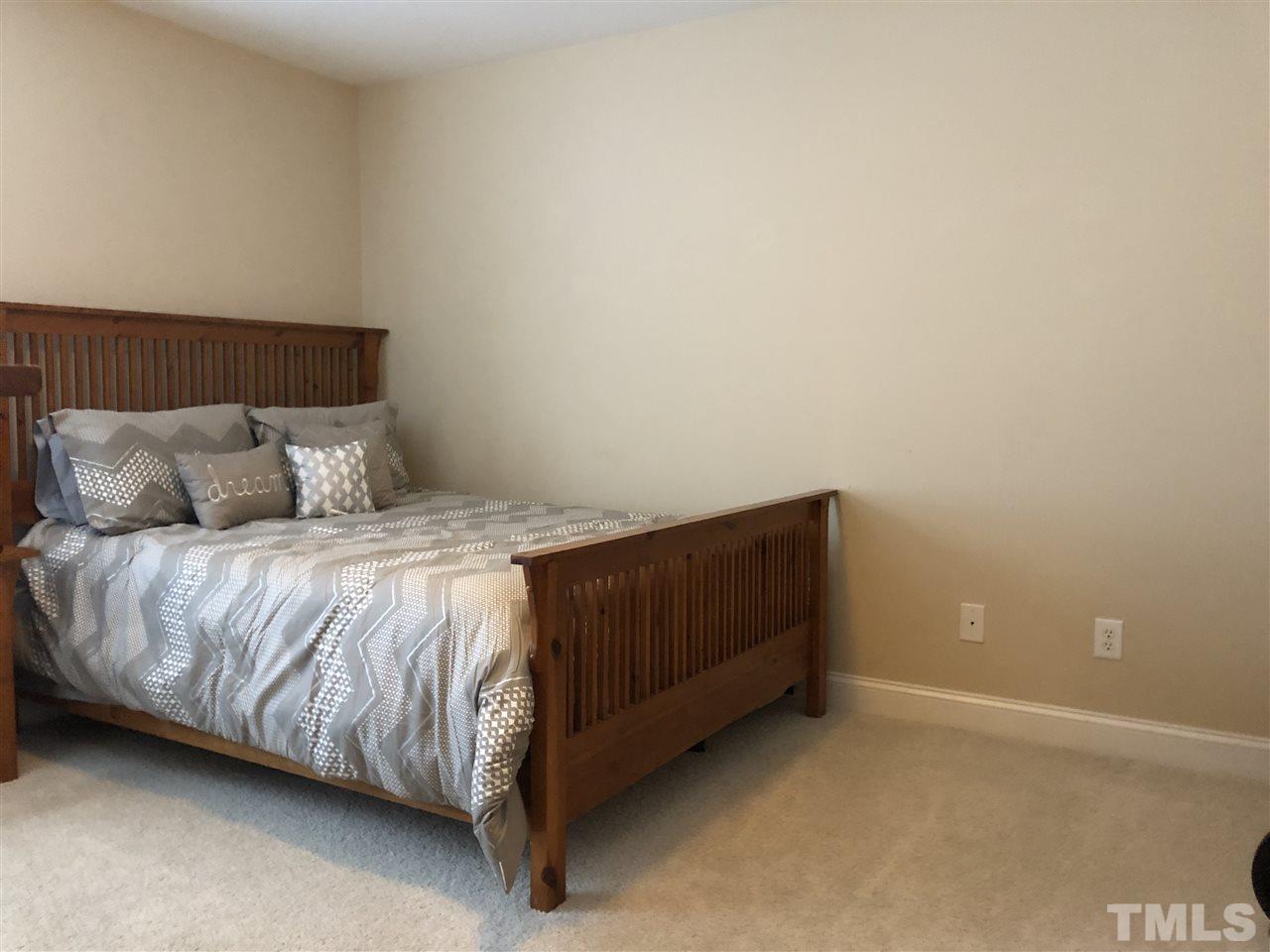 3914 Magnolia Pond Road Raleigh, NC 27610 - Photo 11 of 15 a bedroom with a bed and a window