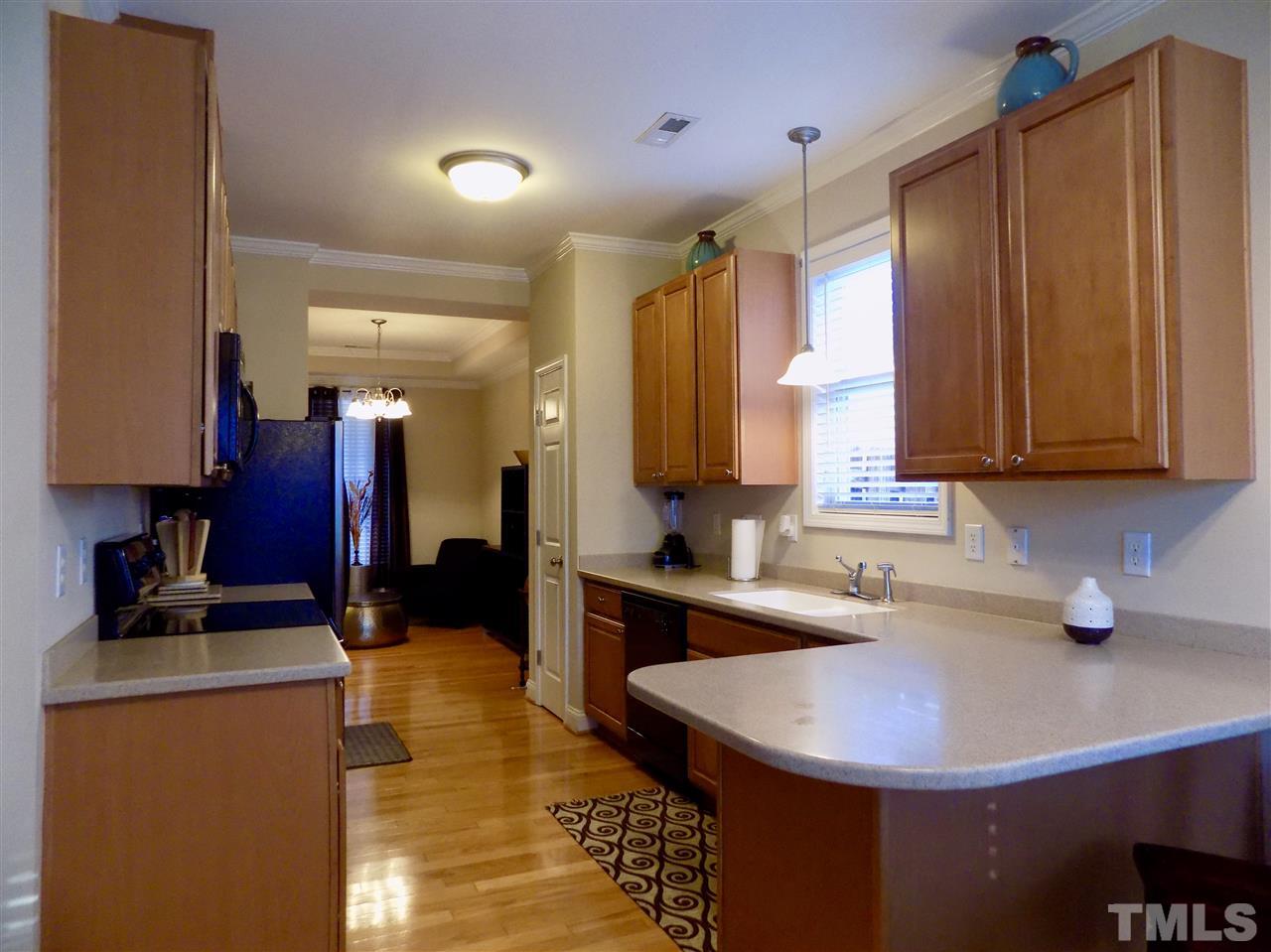3914 Magnolia Pond Road Raleigh, NC 27610 - Photo 4 of 15 a kitchen with a sink cabinets and window